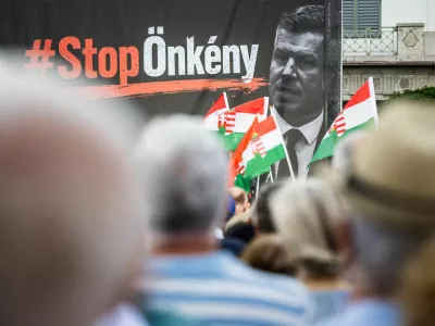 A sign that reads "Stop tyranny" is seen alongside a portrait of Prime Minister Peter Magyar on stage during a protest against a proposed constitutional amendment that would remove President Tamas Sulyok from office in Budapest, Hungary, July 9, 2026. REUTERS/Marton Monus