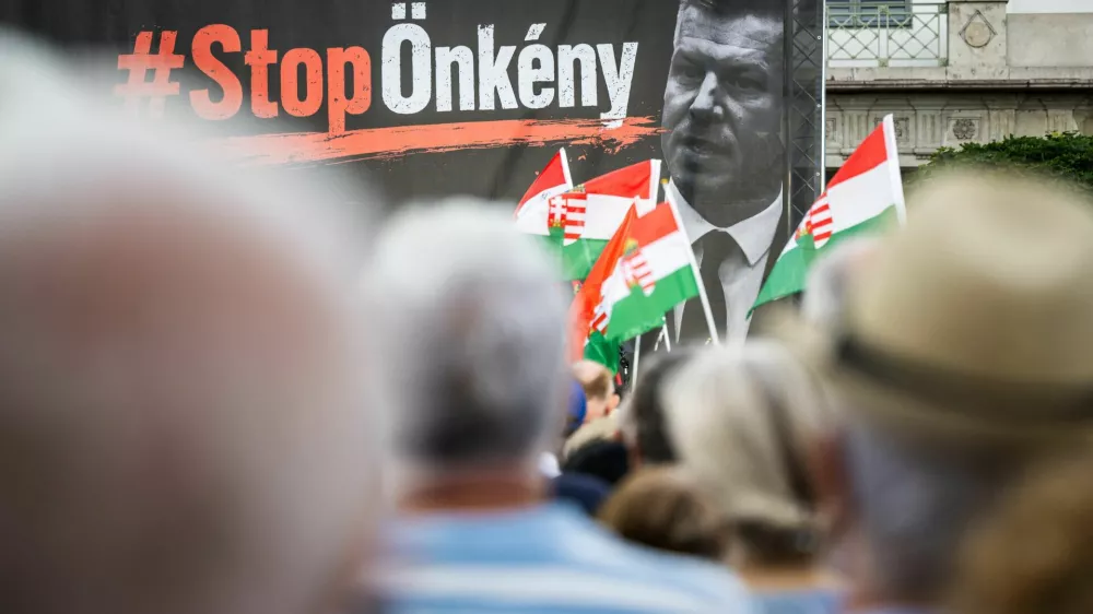 A sign that reads "Stop tyranny" is seen alongside a portrait of Prime Minister Peter Magyar on stage during a protest against a proposed constitutional amendment that would remove President Tamas Sulyok from office in Budapest, Hungary, July 9, 2026. REUTERS/Marton Monus