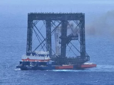 In this photo released by Xinhua News Agency, a drone photo shows the successful capture of the returned first stage of Long March-10B carrier rocket on a seaborne platform via a net-capture system near Wenchang in southern China's Hainan province on Friday, July 10, 2026. (Xing Guangli/Xinhua News Agency via AP)