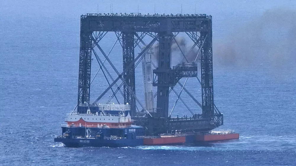 In this photo released by Xinhua News Agency, a drone photo shows the successful capture of the returned first stage of Long March-10B carrier rocket on a seaborne platform via a net-capture system near Wenchang in southern China's Hainan province on Friday, July 10, 2026. (Xing Guangli/Xinhua News Agency via AP)