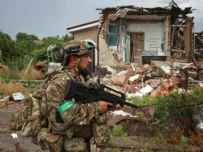 A serviceman of the 49th Separate Assault Battalion Carpathian Sich of the Ukrainian Armed Forces patrols an area during his combat mission, amid Russia's attack on Ukraine, in the frontline town of Druzhkivka, in Donetsk region, Ukraine July 9, 2026. REUTERS/Anatolii Stepanov