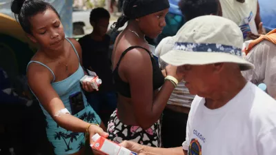 Displaced people gather to receive aid at a makeshift shelter run by the United Nations at a baseball field, in the aftermath of the June 24 earthquakes, in Catia La Mar, La Guaira state, Venezuela, July 9, 2026. REUTERS/Leonardo Fernandez Viloria