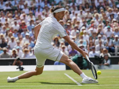 Alexander Zverev of Germany stretches as he plays a return to Arthur Fery of Britain during their men's singles semifinal match at the Wimbledon Tennis Championships in London, Friday, July 10, 2026. (AP Photo/Kirsty Wigglesworth)