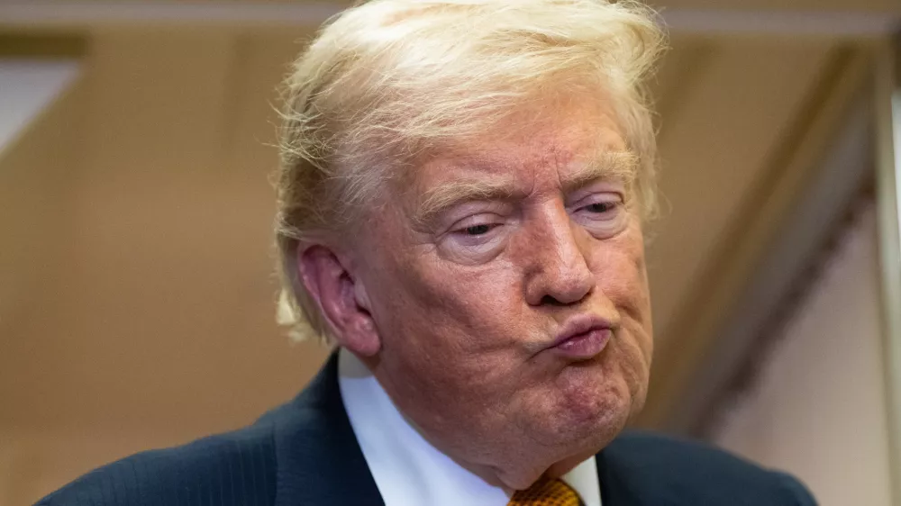 President Donald Trump listens to a question as he speaks with reporters in flight on Air Force One after landing at U.S. Air Force Base at RAF Mildenhall, in Suffolk, Eastern England, Wednesday, July 8, 2026. (AP Photo/Alex Brandon)
