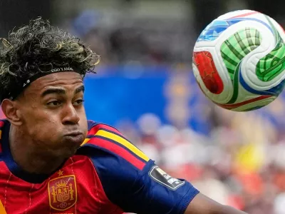 Spain's Lamine Yamal (19), wearing a headband that says 'Ego Yamal', controls the ball during the World Cup quarterfinal soccer match between Spain and Belgium in Inglewood, Calif., near Los Angeles, Friday, July 10, 2026. (AP Photo/Andre Penner)