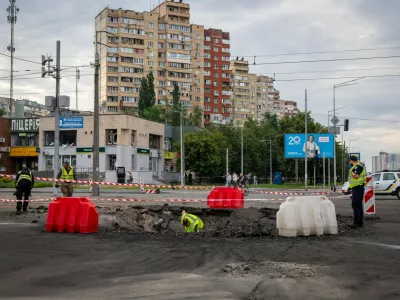 A sapper examines the impact site of a Russian missile in a residential area of ​​Kyiv, Saturday, July 11, 2026. (AP Photo/Dan Bashakov)