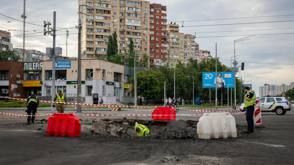 A sapper examines the impact site of a Russian missile in a residential area of ​​Kyiv, Saturday, July 11, 2026. (AP Photo/Dan Bashakov)