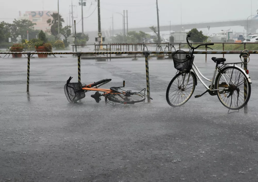A bicycle falls on the ground in the heavy rain as Typhoon Bavi approaches in Ishigaki, Japan, July 10, 2026. REUTERS/Kim Kyung-Hoon