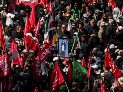 A man raises a picture featuring Iran's Supreme Leader Mojtaba Khamenei and Iran's late Supreme Leader Ayatollah Ali Khamenei, as mourners gather on the day of the burial of Ayatollah Ali Khamenei, who was killed on February 28 in Israeli and U.S. airstrikes, in Mashhad, Iran, July 9, 2026. REUTERS/Alkis Konstantinidis Foreign media in Iran operate under guidelines set by the Ministry of Culture and Islamic Guidance, which regulates press activity and permissions. ISRAEL OUT. NO COMMERCIAL OR EDITORIAL SALES IN ISRAEL. NO ACCESS FOR ISRAELI MEDIA. NO USE BBC PERSIAN. NO USE VOA PERSIAN. NO USE MANOTO. NO USE IRAN INTERNATIONAL. NO USE RADIO FARDA. DIGITAL: NO USE BBC PERSIAN. NO USE VOA PERSIAN. NO USE MANOTO. NO USE IRAN INTERNATIONAL. NO USE RADIO FARDA.