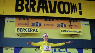 Cycling - Tour de France - Stage 8 - Perigueux to Bergerac - Bergerac, France - July 11, 2026 UAE Team Emirates XRG's Tadej Pogacar celebrates on the podium wearing the yellow jersey after stage 8 REUTERS/Stephanie Lecocq