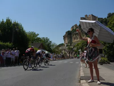 Spectators cheer as breakaway riders race past them during the eighth stage of the Tour de France cycling race of over 180.4 kilometers (about 112 miles) with start in Perigueux and finish in Bergerac, France, Saturday, July 11, 2026. (AP Photo/Thibault Camus)