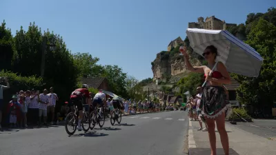 Spectators cheer as breakaway riders race past them during the eighth stage of the Tour de France cycling race of over 180.4 kilometers (about 112 miles) with start in Perigueux and finish in Bergerac, France, Saturday, July 11, 2026. (AP Photo/Thibault Camus)