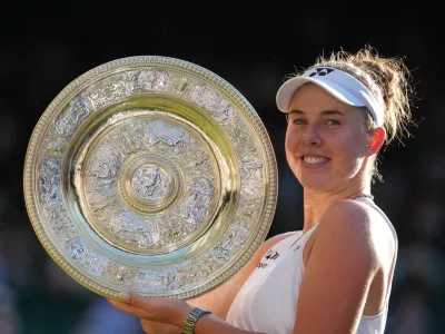 Linda Noskova of Czech Republic poses with the trophy after winning against Karolina Muchova of Czech Republic in the women's singles final at Wimbledon Tennis Championships in London, Saturday, July 11, 2026. (AP Photo/Kirsty Wigglesworth)