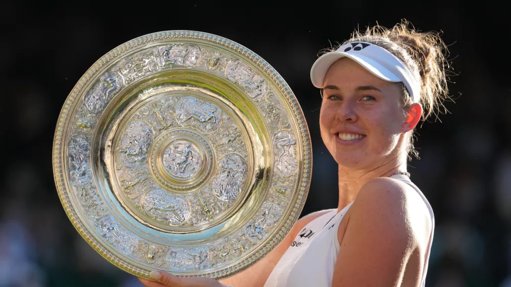 Linda Noskova of Czech Republic poses with the trophy after winning against Karolina Muchova of Czech Republic in the women's singles final at Wimbledon Tennis Championships in London, Saturday, July 11, 2026. (AP Photo/Kirsty Wigglesworth)