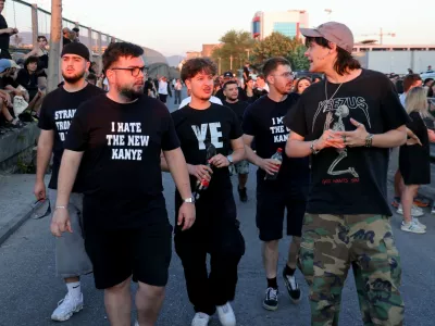 Concertgoers walk to a venue where Ye, the rapper formerly known as Kanye West, will perform in Tirana, Albania, Saturday, July 11, 2026. (AP Photo/Hameraldi Agolli)
