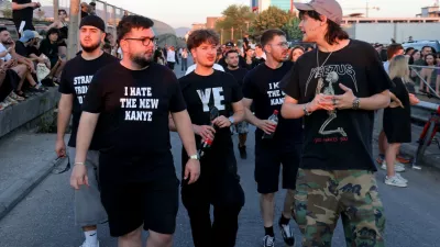 Concertgoers walk to a venue where Ye, the rapper formerly known as Kanye West, will perform in Tirana, Albania, Saturday, July 11, 2026. (AP Photo/Hameraldi Agolli)