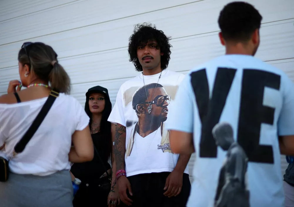 A man wears a shirt bearing the image of U.S. rapper Kanye West, also known as Ye, ahead of the Kanye concert in Tirana, Albania, July 11, 2026. REUTERS/Florion Goga