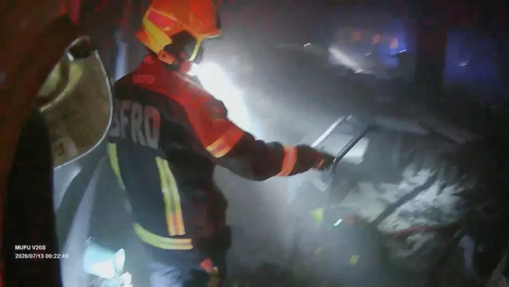A rescue worker inspects the site of a deadly fire at a pub in Bangkok, Thailand, July 13, 2026 in this screengrab taken from bodycam footage of emergency personnel. BANGKOK RESCUE WORKERS GROUP/via REUTERS THIS IMAGE HAS BEEN SUPPLIED BY A THIRD PARTY. MANDATORY CREDIT. NO RESALES. NO ARCHIVES. OVERLAY FROM SOURCE. VERIFICATION:The design of the entrance, windows, tables and light signs of the pub matched archive imagery. Date verified by the files timestamp and official reports