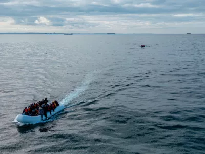FILE PHOTO: In this drone view two inflatable dinghies carrying migrants pass a French navy vessel as they make their way towards England in the English Channel, Britain, May 4, 2024. REUTERS/Chris J. Ratcliffe/File Photo