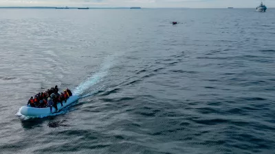 FILE PHOTO: In this drone view two inflatable dinghies carrying migrants pass a French navy vessel as they make their way towards England in the English Channel, Britain, May 4, 2024. REUTERS/Chris J. Ratcliffe/File Photo
