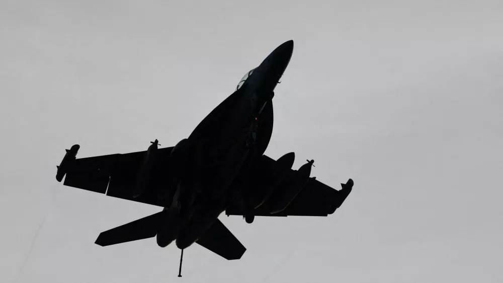 An F-18 fighter jet flies over the USS Theodore Roosevelt as the aircraft carrier participates in Rim of the Pacific (RIMPAC) military exercises in waters south of the Hawaiian Islands, U.S., July 12, 2026. REUTERS/Marco Garcia
