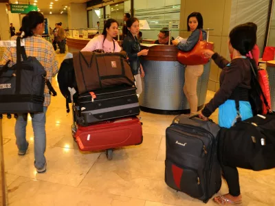 Some on the 30 repatriated Filipino workers arrive at the Manila International Airport on November 4, 2013. Thousands of stranded overseas Filipino workers (OFWs) are in danger of being violently detained, arrested and detained by Saudi authorities as crackdowns are expected to resume in the Kingdom of Saudi Arabia November 3, 2013.,Image: 175867919, License: Rights-managed, Restrictions:, Model Release: no 