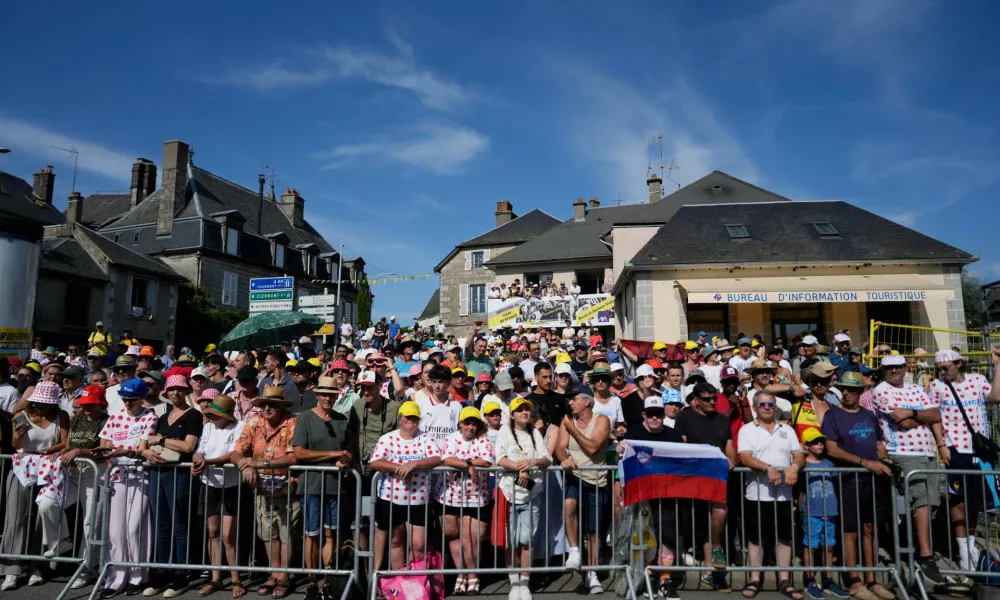 Spectators wait for the riders to pass during the ninth stage of the Tour de France cycling race with start in Malemort and finish in Ussel, France, Sunday, July 12, 2026. (AP Photo/Mosa'ab Elshamy)