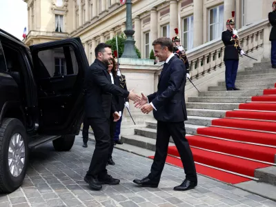 French President Emmanuel Macron shakes hands with Ukrainian President Volodymyr Zelenskiy as he arrives for an Integrated Anti-Ballistic Missile Coalition meeting at the Quai d'Orsay in Paris, before a meeting with countries involved in the 'Coalition of the Willing' supporting Ukraine, on the eve of Bastille Day celebrations, France, July 13, 2026. REUTERS/Tom Nicholson/Pool  TPX IMAGES OF THE DAY