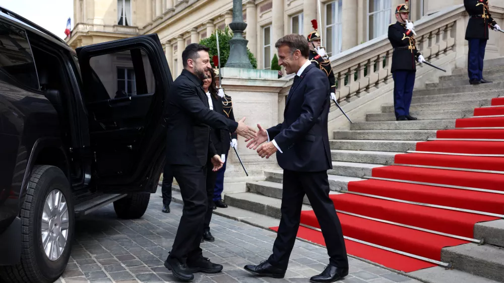 French President Emmanuel Macron shakes hands with Ukrainian President Volodymyr Zelenskiy as he arrives for an Integrated Anti-Ballistic Missile Coalition meeting at the Quai d'Orsay in Paris, before a meeting with countries involved in the 'Coalition of the Willing' supporting Ukraine, on the eve of Bastille Day celebrations, France, July 13, 2026. REUTERS/Tom Nicholson/Pool  TPX IMAGES OF THE DAY