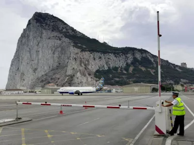 ** FILE ** A policeman patrols a road crossing at the Gibraltar airport, in this Aug. 26, 2001 file photo. Gibraltar could play in future European soccer tournaments _ despite Spain's objections _ after a court ruling in favour of the tiny British colony. The Switzerland-based Court of Arbitration for Sport, or CAS, ruled this month in favour of Gibraltar's petition for provisional membership of UEFA, European soccer's governing body. (AP Photo/Roca Perales)