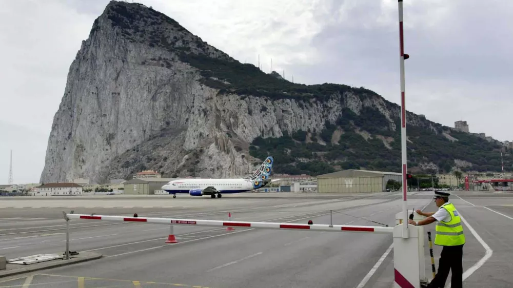 ** FILE ** A policeman patrols a road crossing at the Gibraltar airport, in this Aug. 26, 2001 file photo. Gibraltar could play in future European soccer tournaments _ despite Spain's objections _ after a court ruling in favour of the tiny British colony. The Switzerland-based Court of Arbitration for Sport, or CAS, ruled this month in favour of Gibraltar's petition for provisional membership of UEFA, European soccer's governing body. (AP Photo/Roca Perales)