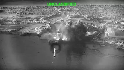 This image from video released by U.S. Central Command, shows an explosion at Bandar Abbas Naval Base, Iran, as three Corsair unmanned surface vessels, also called one-way attack surface drones, fired by the U.S. military, hit the port July 12, 2026. (U.S. Central Command via AP)