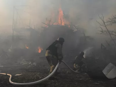Firefighters work at the site of residential houses damaged by a Russian air strike, amid Russia's attack on Ukraine, in Zaporizhzhia, Ukraine, July 13, 2026. REUTERS/Stringer