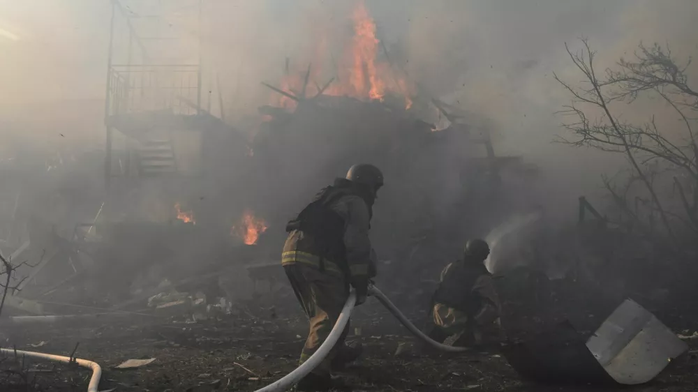 Firefighters work at the site of residential houses damaged by a Russian air strike, amid Russia's attack on Ukraine, in Zaporizhzhia, Ukraine, July 13, 2026. REUTERS/Stringer