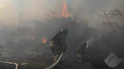 Firefighters work at the site of residential houses damaged by a Russian air strike, amid Russia's attack on Ukraine, in Zaporizhzhia, Ukraine, July 13, 2026. REUTERS/Stringer