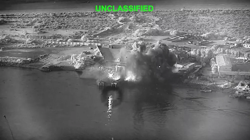 This image from video released by U.S. Central Command, shows an explosion at Bandar Abbas Naval Base, Iran, as three Corsair unmanned surface vessels, also called one-way attack surface drones, fired by the U.S. military, hit the port July 12, 2026. (U.S. Central Command via AP)