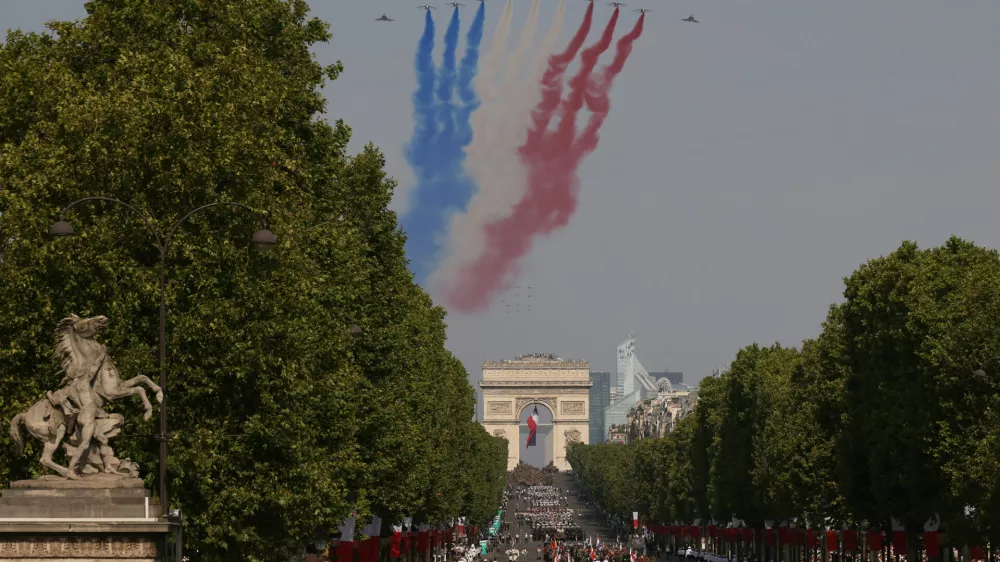 Jets from the acrobatic Patrouille de France fly during the Bastille Day military parade on the Champs-Elysees avenue in Paris, Tuesday, July 14, 2026. (AP Photo/Thomas Padilla)