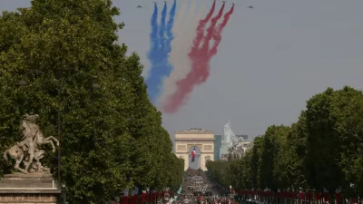Jets from the acrobatic Patrouille de France fly during the Bastille Day military parade on the Champs-Elysees avenue in Paris, Tuesday, July 14, 2026. (AP Photo/Thomas Padilla)