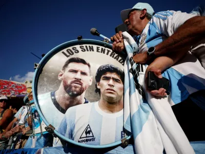 FILE PHOTO: Soccer Football - FIFA World Cup 2026 - Quarter Final - Argentina v Switzerland - Kansas City Stadium, Kansas City, Missouri, U.S. - July 11, 2026 Argentina fans play drums displaying Lionel Messi and Diego Maradona inside the stadium before the match REUTERS/Lee Smith/File Photo