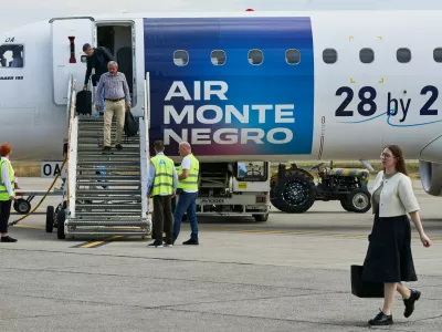 Passengers disembark from a Montenegro flag carrier aircraft bearing the slogan "28 by 28 &ndash; The Next EU Member" at Podgorica Airport in Podgorica, Montenegro, June 3, 2026. REUTERS/Stevo Vasiljevic