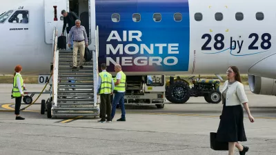 Passengers disembark from a Montenegro flag carrier aircraft bearing the slogan "28 by 28 &ndash; The Next EU Member" at Podgorica Airport in Podgorica, Montenegro, June 3, 2026. REUTERS/Stevo Vasiljevic