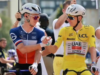 Cycling - Tour de France - Stage 10 - Aurillac to Le Lioran - Aurillac, France - July 14, 2026 UAE Team Emirates - XRG's Tadej Pogacar wearing the yellow jersey with Groupama - FDJ United's Romain Gregoire before the start of stage 10 REUTERS/Stephanie Lecocq