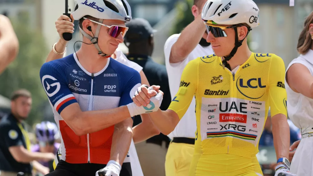 Cycling - Tour de France - Stage 10 - Aurillac to Le Lioran - Aurillac, France - July 14, 2026 UAE Team Emirates - XRG's Tadej Pogacar wearing the yellow jersey with Groupama - FDJ United's Romain Gregoire before the start of stage 10 REUTERS/Stephanie Lecocq