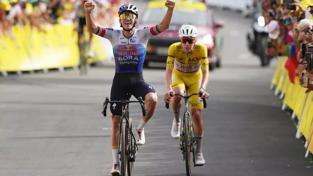 Belgium's Remco Evenepoel celebrates as he crosses the finish line ahead Slovenia's Tadej Pogacar to win the fifteenth stage of the Tour de France cycling race, from Champagnole to the Plateau de Solaison, France, Sunday, July 19, 2026. (AP Photo/Thibault Camus)
