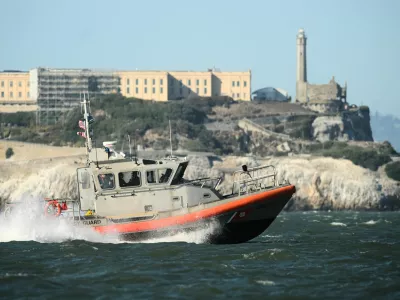 A U.S. Coast Guard crew goes past Alcatraz Island near the site of a pontoon boat accident on Tuesday, July 14, 2026, in San Francisco. (AP Photo/Noah Berger)