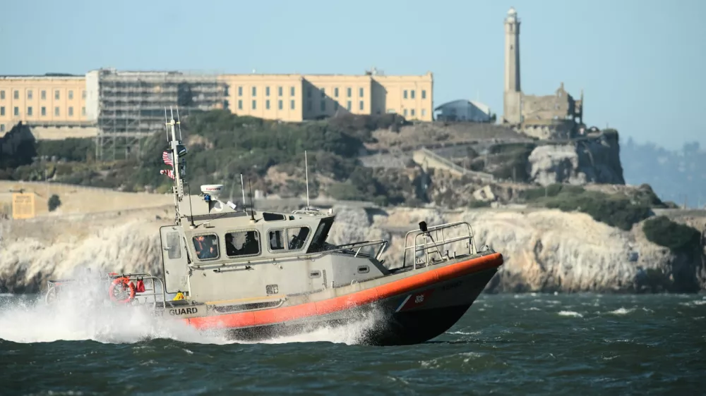 A U.S. Coast Guard crew goes past Alcatraz Island near the site of a pontoon boat accident on Tuesday, July 14, 2026, in San Francisco. (AP Photo/Noah Berger)