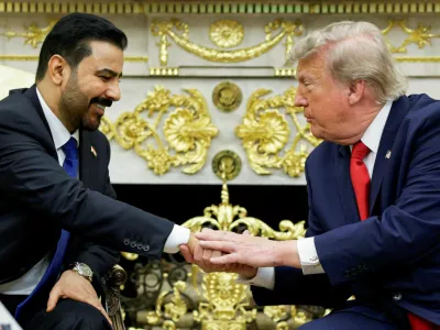 U.S. President Donald Trump shakes hands with Iraqi Prime Minister Ali al-Zaidi as they participate in a bilateral meeting in the Oval Office at the White House in Washington, D.C., U.S., July 14, 2026. REUTERS/Evan Vucci   TPX IMAGES OF THE DAY