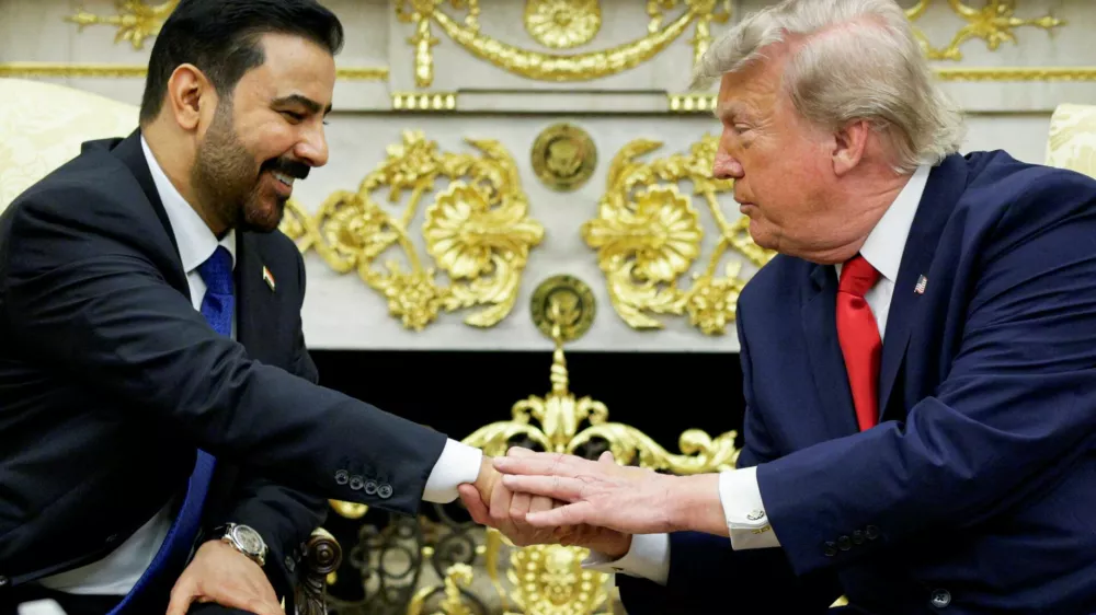 U.S. President Donald Trump shakes hands with Iraqi Prime Minister Ali al-Zaidi as they participate in a bilateral meeting in the Oval Office at the White House in Washington, D.C., U.S., July 14, 2026. REUTERS/Evan Vucci   TPX IMAGES OF THE DAY