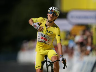 Cycling - Tour de France - Stage 10 - Aurillac to Le Lioran - Le Lioran, France - July 14, 2026 UAE Team Emirates - XRG's Tadej Pogacar wearing the yellow jersey celebrates winning stage 10 REUTERS/Gonzalo Fuentes