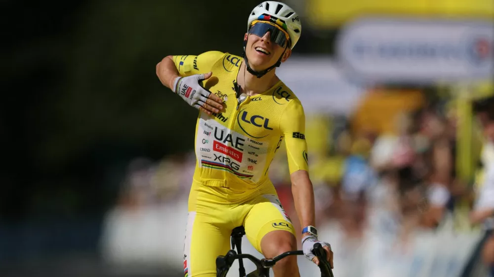 Cycling - Tour de France - Stage 10 - Aurillac to Le Lioran - Le Lioran, France - July 14, 2026 UAE Team Emirates - XRG's Tadej Pogacar wearing the yellow jersey celebrates winning stage 10 REUTERS/Gonzalo Fuentes
